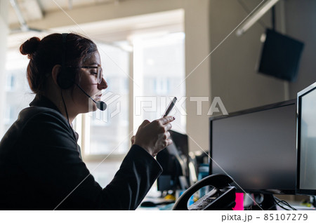 Caucasian woman uses a smartphone at the workplace. Caucasian woman uses a smartphone at the workplace. 85107279