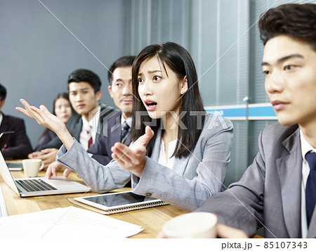 young asian business woman executive engaging in a heated discussion during meeting 85107343