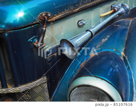 Fragment of a shiny blue retro car with a signal horn outside and splattered with dirt. Closeup photo Fragment of a shiny blue retro car with a signal horn outside and splattered with dirt. Closeup photo 85107616