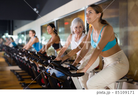 Young girl on training using bike in gym 85109171