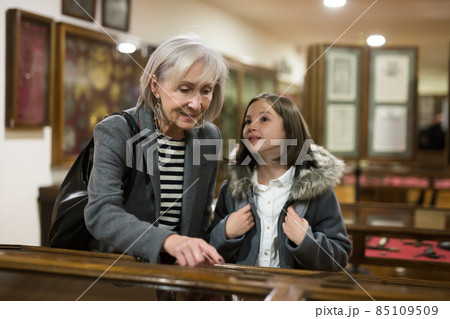 Preteen girl with grandmother exploring ancient artworks in museum Preteen girl with grandmother exploring ancient artworks in museum 85109509