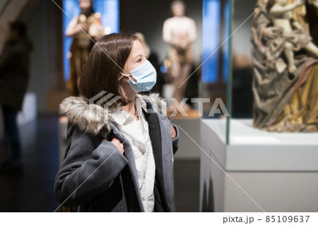 Tween schoolgirl in medical mask observing arts and crafts in gallery 85109637