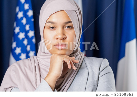 Young serious female delegate in hijab looking at camera 85109963