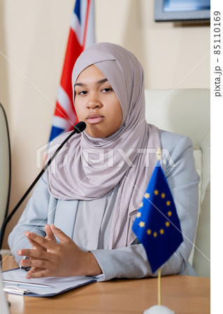 Young successful female politician in hijab making report 85110169