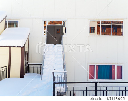 Back entrance to the building with snow-strewn steps and porch Back entrance to the building with snow-strewn steps and porch 85113006