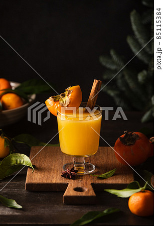 Persimmon and tangerine juice bourbon cocktail Persimmon and tangerine juice bourbon cocktail 85115384