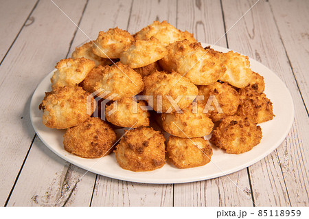 Rocher coco from coconut dessert in brown color make with white eggs and sugar.  85118959