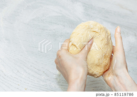 girl is holding a raw dough for buns. the concept of home cooking. making homemade dough girl is holding a raw dough for buns. the concept of home cooking. making homemade dough 85119786