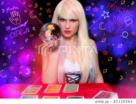 Psychic with Blond hair and Crystal Ball. Neon Lights in background Psychic with Blond hair and Crystal Ball. Neon Lights in background 85120563