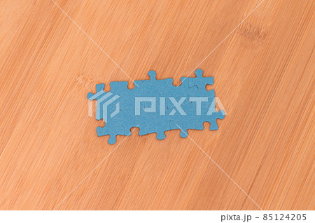 Puzzle Pieces on Wooden Table 85124205