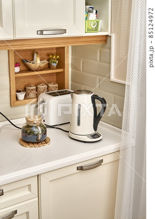Teapot near hot drink electric kettle and toaster in kitchen 85124972