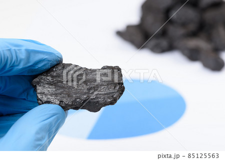 Coal lump in scientist hand 85125563