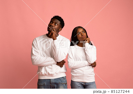Confused african american man and woman looking aside Confused african american man and woman looking aside 85127244
