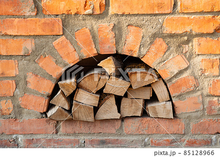firewood in a red brick oven 85128966