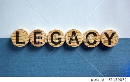 Wood circles with word 'legacy' on paper blue and white background, copy space. Business concept success process. 85129072