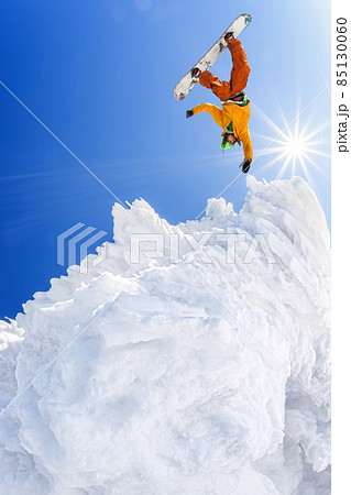Snowboarder jumping against blue sky in high mountains Snowboarder jumping against blue sky in high mountains 85130060