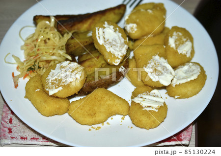 Chicken nuggets breaded pieces of meat on a plate 85130224