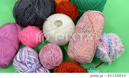 Multi-colored threads for knitting lie on the chromakey table Multi-colored threads for knitting lie on the chromakey table 85130834