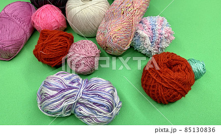 Multi-colored threads for knitting lie on the chromakey table 85130836