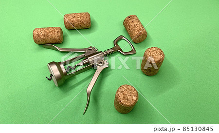 Steel wine corkscrew together with wooden corks lie on the chromakey table Steel wine corkscrew together with wooden corks lie on the chromakey table 85130845