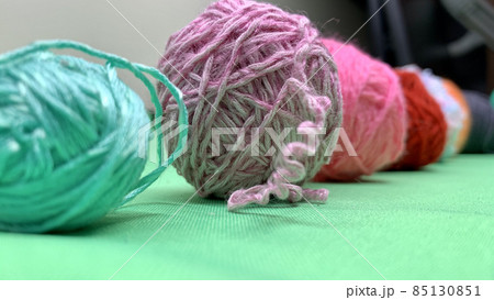 Multi-colored threads for knitting lie on the chromakey table 85130851