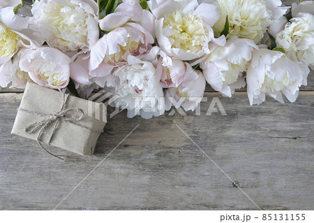 Beautiful celebration background; frame of white peonies and handmade gift box on old wooden background; copy space, 85131155