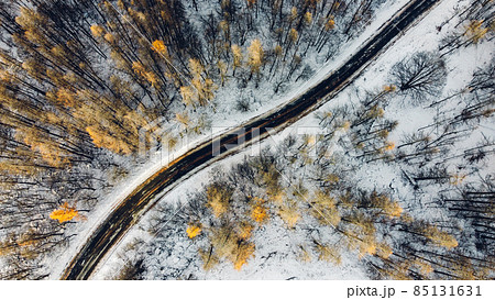 Aerial high angle view of narrow curvy road. Aerial high angle view of narrow curvy road. 85131631