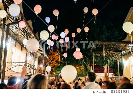 Crowd Throwing Colorful Balloons to Sky at night During Festival or wedding party 85131985