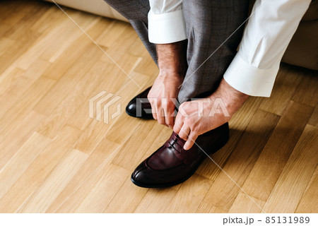 businessman putting on shoes, man getting ready for work, groom morning before wedding ceremony 85131989