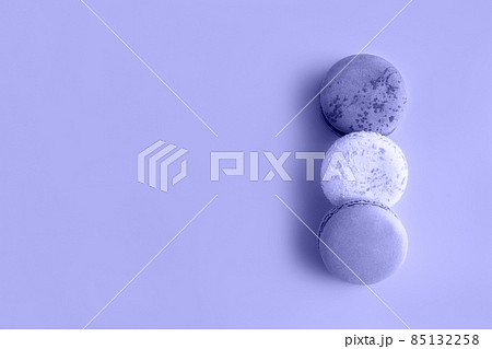 Three macaroons in flat lay style toned in trendy color of year 2022. Trendy background for your design. Color 2022 concept. Food concept in vintage style. Copy space. Three macaroons in flat lay style toned in trendy color of year 2022. Trendy background for your design. Color 2022 concept. Food concept in vintage style. Copy space. 85132258