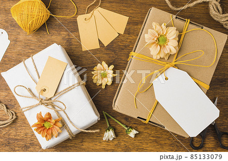 wrapped gift tied with tag string beautiful flower wooden surface. High quality photo wrapped gift tied with tag string beautiful flower wooden surface. High quality photo 85133079