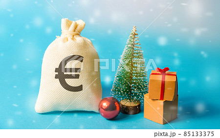 Euro money bag, Christmas tree and miniature houses. Accumulating money and planning a budget. Business and finance. Loans, deposit, credit. Promotions, offers. Selective focus Euro money bag, Christmas tree and miniature houses. Accumulating money and planning a budget. Business and finance. Loans, deposit, credit. Promotions, offers. Selective focus 85133375