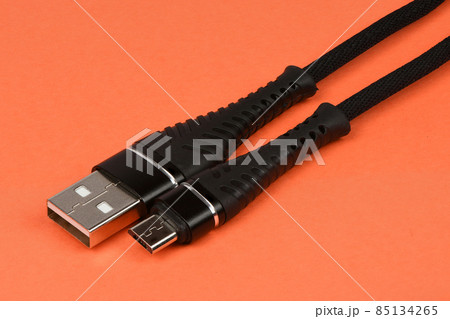 Closeup of an USB connector isolated on orange. Closeup of an USB connector isolated on orange. 85134265