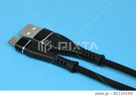 Closeup of an USB connector isolated on blue. Closeup of an USB connector isolated on blue. 85134269