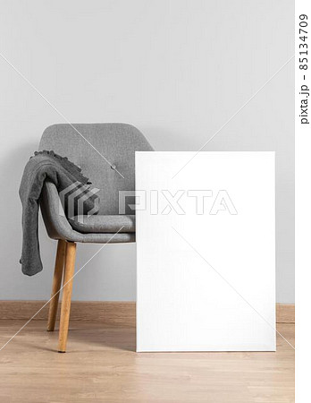frame mock up beside chair. High quality photo 85134709