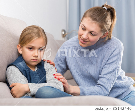 Mother comforts offended little daughter at home 85142446
