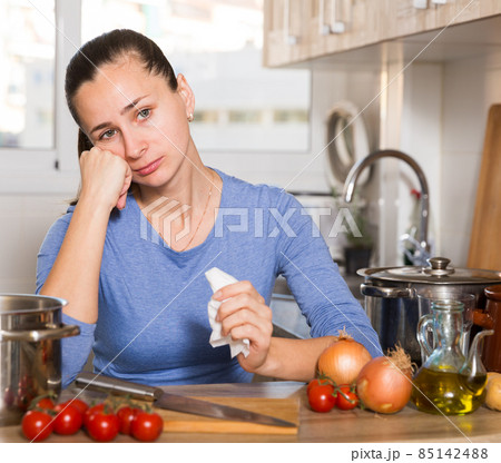 Upset housewife standing at kitchen 85142488