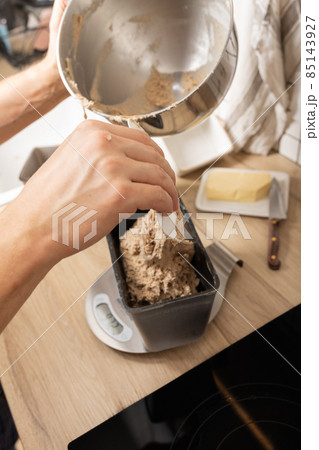 The process of making rye bread. The dough on the rye bread is laid out in a mold. Top view. The process of making rye bread. The dough on the rye bread is laid out in a mold. Top view. 85143927
