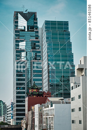 View of ITF Tower, Silom Palace with the top of a traditional Thai building in the foreground View of ITF Tower, Silom Palace with the top of a traditional Thai building in the foreground 85146386