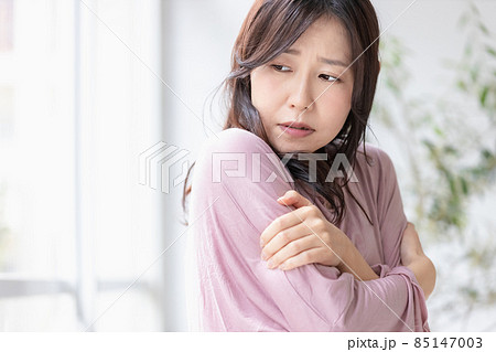 部屋の中で寒さに凍える女性 85147003