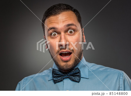 Portrait young man in blue shirt, looking with amazement Portrait young man in blue shirt, looking with amazement 85148800