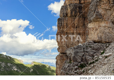 A steep cliff in the Italian Dolomites with the characteristic structure and color of the rock A steep cliff in the Italian Dolomites with the characteristic structure and color of the rock 85150535