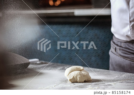 Making dough for bread by male hands in restaurant kitchen. Cooking concept. 85158174