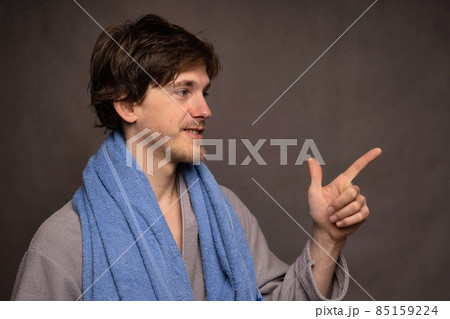 Man with bath towel on grey background Man with bath towel on grey background 85159224