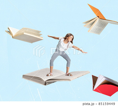 Contemporary art collage of little cheerful girl, child surfing on open book isolated over light blue background Contemporary art collage of little cheerful girl, child surfing on open book isolated over light blue background 85159449