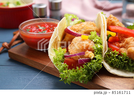Delicious fish tacos served on blue wooden table, closeup Delicious fish tacos served on blue wooden table, closeup 85161711
