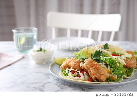 Yummy fish tacos served on white marble table, space for text Yummy fish tacos served on white marble table, space for text 85161732