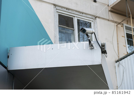 CCTV camera on the facade of a residential building. 85161942