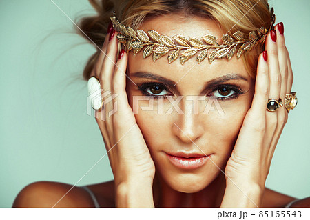 young blond woman dressed like ancient greek godess, gold jewelry close up isolated, beautiful girl hands manicured red nails young blond woman dressed like ancient greek godess, gold jewelry close up isolated, beautiful girl hands manicured red nails 85165543