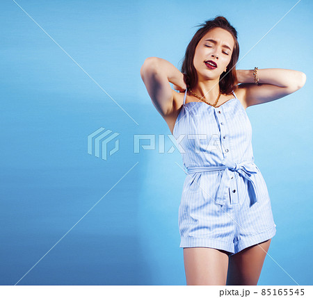 young pretty girl in sunglasses posing happy smiling on blue background, lifestyle people on summer vacation concept young pretty girl in sunglasses posing happy smiling on blue background, lifestyle people on summer vacation concept 85165545